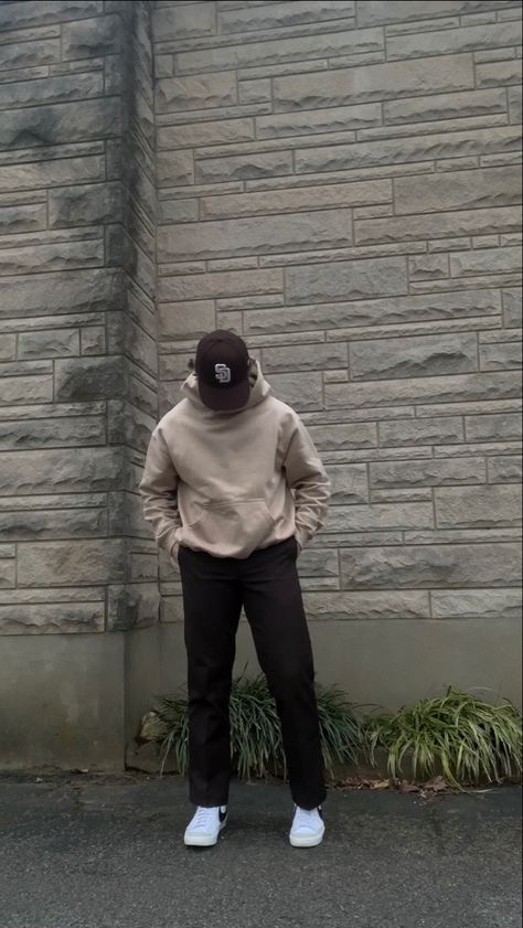 A simple streetwear outfit featuring neutral colors. The outfit includes a brown San Diego Padres hat, a khaki oversized hoodie from Rue Porter, brown Dickies 874 pants, and white Nike blazer mid 77’ sneakers with the black swoosh. Nike Hoodie Men Outfit, Fits With Nike Blazers Men, Light Brown Hoodie Outfit Men, Neutral Men Outfit, Tan Hoodie Outfit Men, Neutral Outfits For Men, Brown Crewneck Outfit Men, Nike Blazer 77 Outfit Men, Tan Outfit Men