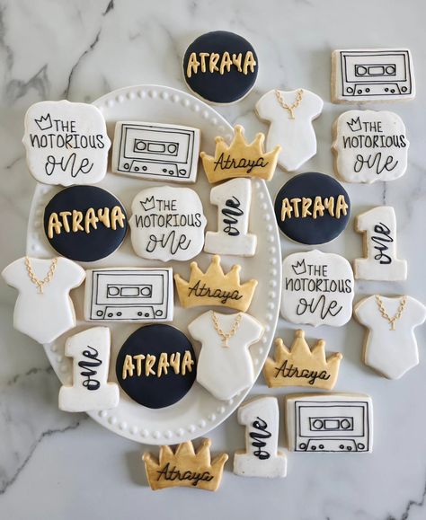 The Notorious One 👑📼 • #cookie #cookies #decoratedcookies #cookiesofinstagram #cookiehack #cookietip #cookiedecorating #satisfying #satisfyingreel #cookier #newcolors #thisweekscolors #jdsugarcookies #sugarcookies #royalicing #thenotoriousone #thenotorious #birthdaysugarcookies #firstbirthdaycookies #one #crowncookies #cassette #cassettecookies #necklacecookies #onesiecookies One Birthday Cookies, Notorious One Birthday, Notorious One, Crown Cookies, First Birthday Cookies, Onesie Cookies, Cookie Hacks, Sons Birthday, Birthday Cookies