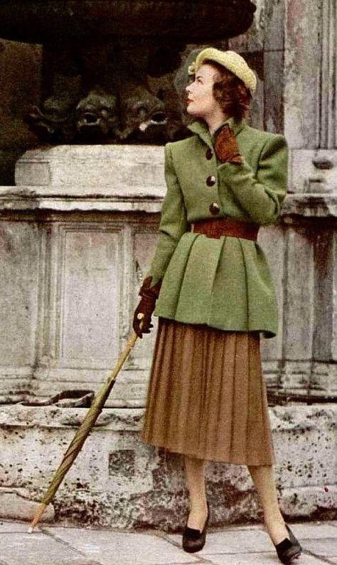 1947 Model is wearing a long moss-green belted jacket over brown pleated skirt by Jacques Fath late 40s winter wear casual day jacket skirt hat shoes gloves belt green brown tan wool warm 40s Mode, 1940s Fashion Women, Brown Pleated Skirt, Jacques Fath, Fashion 1940s, Brown Skirt, 40s Fashion, Style Inspiration Fall, Belted Jacket