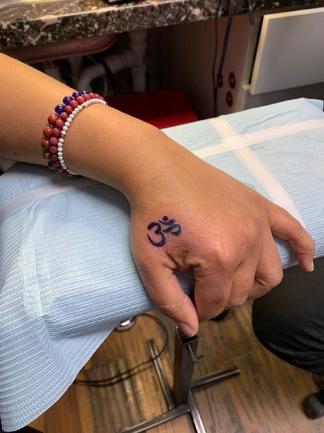 Left hand tattoo of  the OM  symbol Om Hand Tattoos, Om Tattoo Hand, Hand Tattoo Thumb, Om Tattoo On Hand, Small Thumb Tattoos, Thumb Tattoo, 80s Style Outfits, Thumb Tattoos, Om Tattoo Design