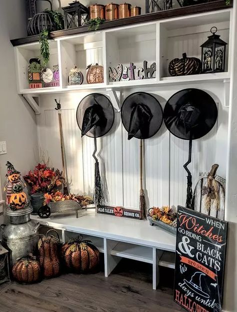 A traditional Halloween mudroom with black witches' hats, brooms, pumpkins and faux pumpkins and a sign Halloween Mudroom, Witch Halloween Decor, Black Witches, Decorations For Halloween, Spooky Ideas, Traditional Halloween, Entryway Style, Witches Hats, Halloween Front Doors