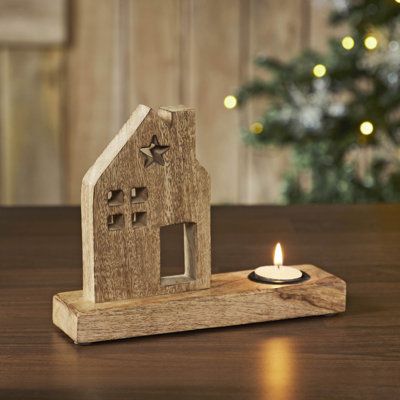 Add a touch of primitive charm to your home decor with the VHC Brands Tropical Wood Tealight Holder featuring a Wooden Saltbox House design. Crafted from tropical wood in a natural Wood Brown finish, this candle holder exudes rustic elegance and warmth, making it an ideal addition to your kitchen, dining table, entryway, or living room. The cutout saltbox house silhouette adds a quaint and cozy feel, while the star-shaped cutout on the roof enhances its rustic appeal, creating a captivating acce Rustic Wooden Christmas Decor, 4x6 Wood Projects, Christmas Woodworking Projects, Woodworking Candle Holder, Wood Tea Light Holder, Saltbox Houses, Wooden Christmas Crafts, Small Woodworking Projects, Wooden Candle Holders