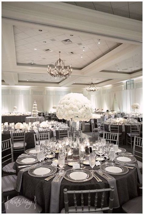 White centerpieces and charcoal gray and silver linens for a deluxe look. Photo: kristinviningphotoblog. Silver Chiavari Chairs, Silver Wedding Decorations, White Weddings Reception, Elegant Wedding Reception, 25th Wedding Anniversary, Black And White Decor, Wedding Decor Elegant, Gray Weddings, Nc Wedding