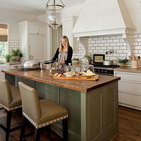 The thick butcher-block top and earth-toned base lend the central island the worn look of an old farm table, distinguishing it from surrounding off-white cabinetry topped in waxed limestone. #kitchendecor #stylishislands Butcher Block Kitchen Island, Functional Kitchen Island, Green Island, Butcher Block Kitchen, White Kitchen Island, Dream Kitchens Design, Gathering Room, Subway Tiles, Functional Kitchen