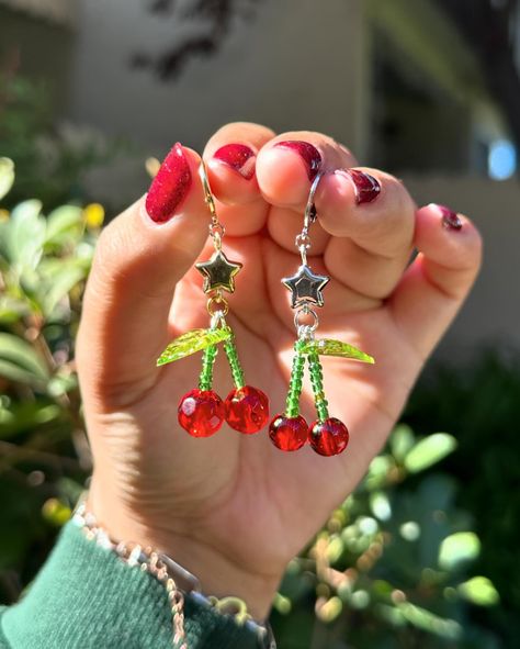 Freshly picked cherries (earrings) I love love love making cherries <3 I decided to revamp them a little since i sold out of my last batch! Now they will include a star bead 🌟 :] also made a few with some lucky dice ;) 🎲 Available in gold & silver Cherry Beaded Earrings, Cherry Earrings, Freshly Picked, Earrings Diy, Bead Charm Bracelet, Beading Wire, I Love Love, Ear Rings, Diy Earrings