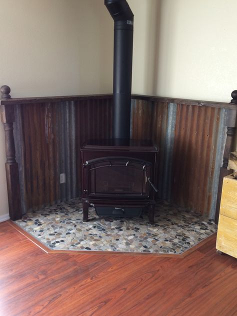 Rustic hearth Wood Stove Hearth Pads Farmhouse, Cabin Wood Stove Hearth, Tin Wall Behind Wood Stove, Cement Board Behind Wood Stove, Wood Stove Mantle Ideas, Corner Hearth Ideas, Rustic Wood Stove Surround, Wood Stove Corner Ideas, Woodstove Mantle