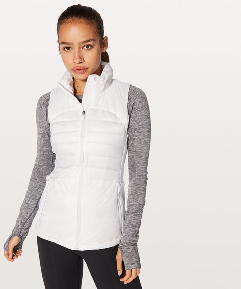 Slip this lightweight,  slim-fitting vest on over your  jacket or long sleeve for  chilly outdoor runs. The high  neck and 800-fill-power goose  down keep you warm while the  water-resistant fabric helps  keep you dry. Lululemon Vest, White Puffer Vest, Slim Vest, Windrunner Jacket, Weighted Vest, Lightweight Vest, Running Vest, Lululemon Jacket, Reversible Vest