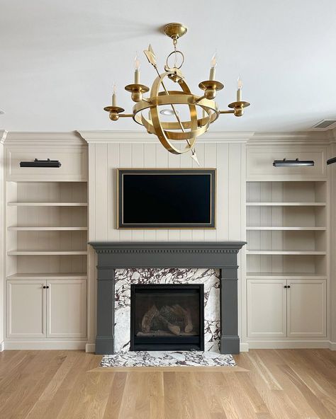 Clearstone Builders | Upstairs office featuring surround built ins, a statement light, and dramatic fireplace. Architect: @the_fox_group_ Build, Photo:... | Instagram Fake Fireplace Built In, Uneven Built Ins Around Fireplace, Transitional Built Ins, Office Fireplace Ideas, Traditional Fireplace With Built Ins, Custom Fireplace Built Ins, Fireplace And Bookcases Built Ins, Gray Built Ins Living Room, Built Ins Beside Fireplace