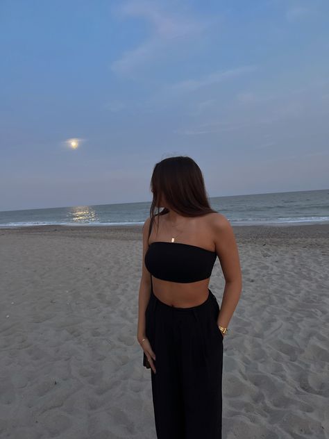 black bandeau top, gold jewelry, black trousers, beach fit, summer, vacation fit Black Beach Dinner Outfit, Black Pants Beach Outfit, Black Beach Pants Outfit, Bandeau Top Outfits Summer, Flowy Black Pants Outfit, Black Bandeau Outfit, Black Bandeau Top Outfit, Beach Pants Outfit Summer, Black Beach Outfit