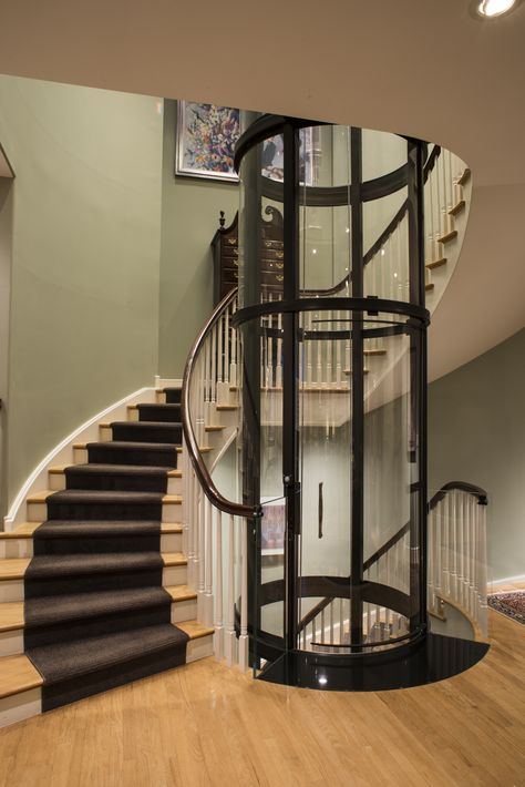 Spiral staircase with 3 stop round Vuelift home elevator Accessibility Architecture, Round Stairs, Stair Elevator, Chicago Luxury, Stair Plan, Lift Lobby, House Lift, Circular Stairs, Elevator Interior