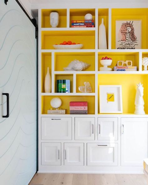 Funky Built In Shelves, Yellow Bookcase, Cream Bookshelves, Desert Apartment, Yellow Bookshelf, Yellow Bookshelves, Colorful Bookshelf, Bookshelves With Tv, White Bookshelves