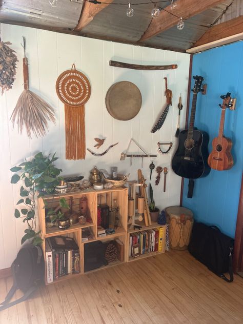 Shaman’s instrument and shaker display with wood crate bookshelves. Turn instruments and trinkets into beautiful, homey decor. Hanging guitar, ukulele, drum, yarn mandala, singing bowls, wood flute, wind chimes, tarot, tepi, kuripe display. Hanging Instruments On Wall, Instrument Organization, Crate Bookshelves, Instrument Room, Wood Flute, Hanging Guitars, Display Living Room, Instrument Display, Yarn Mandala