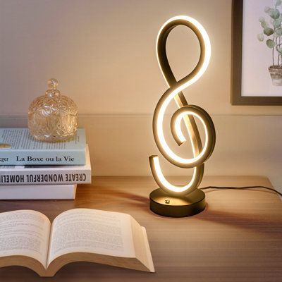 This rgb table lamp has an elegant music note aesthetic design. The black finish painted add a sense of personality. The sprial design supplies a stable and soft light also creates a comfortable atmosphere of artistic aesthetic. It is a unique table lamp for living room, bed room, office or as a bedside or night lamp for your bedroom decor. Wrought Studio™ | Wrought Studio™ Jakie Metal Novelty Lamp 15.74 H x 6.1 W x 4.72 D in / whitePlastic / Metal in Black | 15.74" H X 6.1" W X 4.72" D | Wayfai Touch Lamps For Bedroom, Bed Lamp Aesthetic, Music Note Aesthetic, Music Decor Bedroom, Aesthetic Lamps Bedroom, Music Corner Living Room, Music Table Decorations, Music Room Aesthetic, Bedroom Decor Music