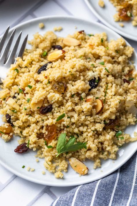 This Moroccan couscous recipe is a simplified, vegan version of the traditional dish, filled with sweet raisins, crunchy almonds and herbs. It might not be authentic, but it makes for an easy, flavorful side dish. Serve it warm with roasted vegetables or your favorite protein. Couscous With Raisins, Moroccan Pearl Couscous Recipes, Bean Sides, Pearl Couscous Recipes, Simply Whisked, Sweet And Spicy Shrimp, Tiny Pasta, Moroccan Couscous, Couscous Recipe