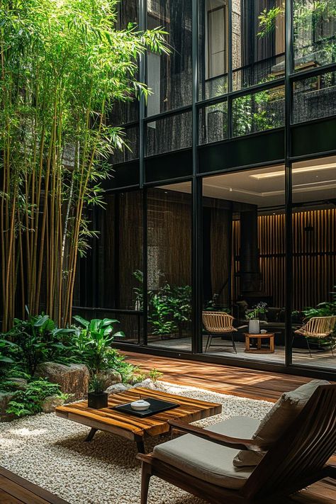 Indoor courtyard of a modern building glass encased lush bamboos lining building walls wooden deck with chairs and modern coffee table wooden slat. Who says gardens cannot be indoors? How about a courtyard? Spend time outside but inside at the same time in these captivating indoor courtyards. Courtyard Apartments, Japanese Modern House, Indoor Courtyard, Atrium House, Garden Court, Narrow House Designs, Modern Residential Architecture, Cozy Interior Design, Tropical House Design