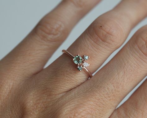 Pretty little cluster ring, a green tourmaline ring with a 4mm round mint tourmaline as the center stone, and a pear white diamond, round blue diamond and round green sapphire as side stones. A special and unique mini engagement, anniversary or wedding cluster ring can also be a perfect modern October birthstone ring. The design can be made with gemstones of your choosing. If you would prefer a custom ring, please contact us before purchase. Please take a look at a larger tourmaline cluster ring Aquamarine Engagement Ring Vintage, Tourmaline Engagement Ring, Green Tourmaline Ring, Marquise Shape Diamond, Unique Engagement Ring, Engagement Ring White Gold, Cluster Engagement Ring, Ring Rose Gold, White Gold Jewelry