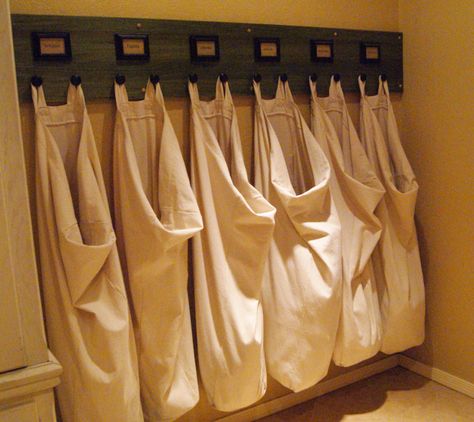 Laundry Organization (practical w/ design:) Bags hung on hooks to sort as things get dirty & keep laundry off the floor.#homeorganization Laundry Storage Solutions, Hanging Laundry Bag, Laundry Room Organization Storage, Laundry Sorting, Small Laundry Room Organization, Room Storage Diy, Farmhouse Laundry, Farmhouse Laundry Room, Small Closet Organization