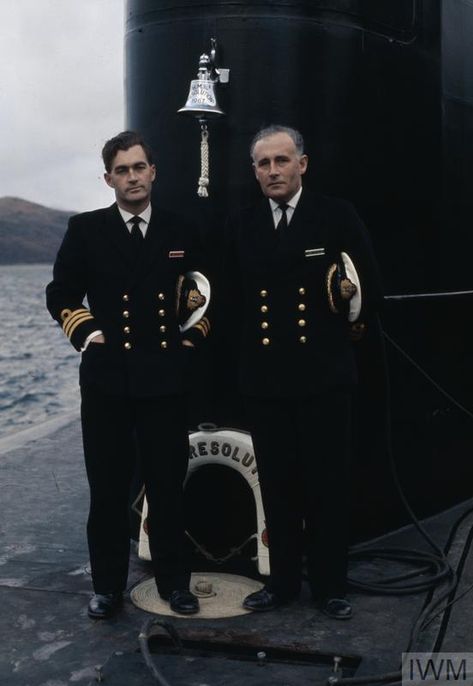 The two Commanding Officers of the Royal Navy's first Polaris submarines HMS RESOLUTION, Commander M C Henry (port crew) and Commander K D Frewer (starboard crew). They are standing on the forward casing just in front of the fin. The ship's bell can be seen affixed to the fin. Royal Navy Uniform, Navy Ranks, Royal Navy Officer, Navy Uniform, Judge Judy, Nuclear Submarine, Navy Uniforms, Oc Inspo, Diy Sewing Clothes