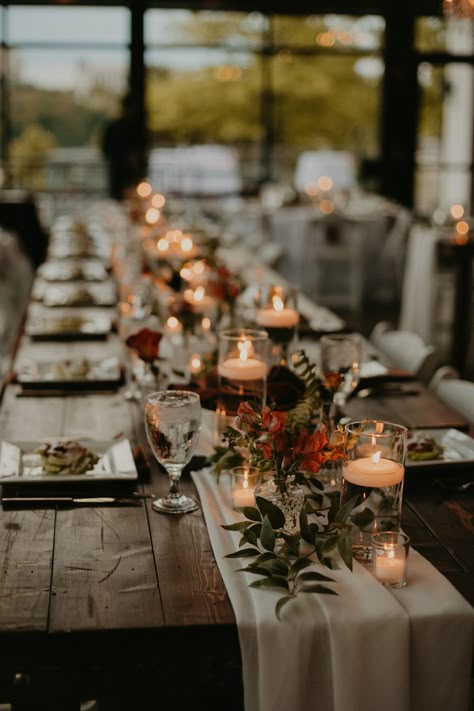 Wedding Table Decor with Cheesecloth Runner and Greenery Arrangements with Floating Candle Centerpieces Rustic Candle Centerpieces Wedding, Rustic Wedding Candles, Fall Wedding Simple Table Decor, Dark Teal Fall Wedding, Floating Candles And Flowers Centerpiece, Floating Candle Centerpieces Long Table, Fall Wedding Centerpieces Candles, Floating Candle Table Decor, Candle Lit Table Setting