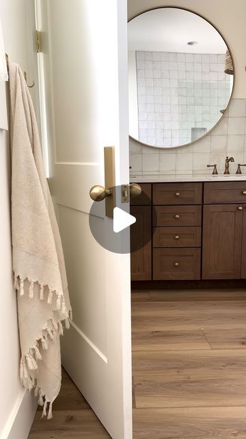 KNOXVILLE HOME BUILDER | Derek & Marina Wiersma on Instagram: "Save this post if you’re looking to add warmth and character to your bathroom ✨  We wanted this small bathroom to feel like a comfortable place where we could have a relaxing end to our day. The wood and brass tones add warmth while the tile and linen add texture. Details listed below 🤍  Floors: @coretecfloors Wiltshire Oak Tile: MLW Piazza Tile - White  Faucets: @deltafaucet  Lights: @crateandbarrel  Door hardware: @emtek_products   #bathroomdesign #bathroominspiration #bathroomdetails #tile #bathroomtile #housedesign #housetohome #houseinspo" Bathroom Light Wood Floor, Oak Bathroom Floor, Lvp Bathroom, Wood Floor In Bathroom, Bathroom With Hardwood Floors, Bathroom Wood Floor, Wood Bathroom Floor, Bathroom Selections, Natural Oak Flooring