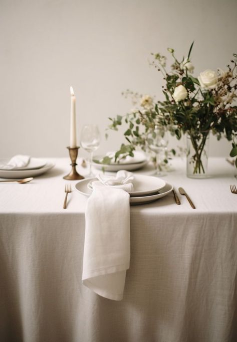 Create the perfect ambiance for an elegant wedding with a beautifully set table featuring a linen tablecloth. The soft and luxurious texture of the linen adds a touch of sophistication to the overall decor. Pair it with delicate china, sparkling glassware, and polished silverware to create a stunning tablescape. The neutral color of the linen allows for endless possibilities when it comes to floral arrangements and centerpiece designs. Tablecloth Inspiration, Gray Tablecloth, Linen Table Settings, Floral Table Setting, Green Tablescape, Natural Farmhouse, Elegant Backdrop, Dining Table Cloth, White Linens