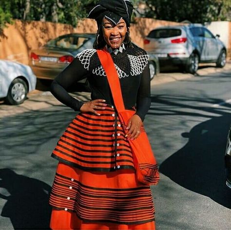 Bride In Red Xhosa Umbhaco Skirt and Bag With Black Top, Doek, and Beaded Cape South Africa Style, Xhosa Outfits, Xhosa Traditional Dresses, Traditional African Attire, Xhosa Culture, Md Dresses, Xhosa Traditional Attire, Xhosa Attire, South African Traditional Dresses