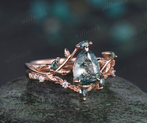 - Metal: Solid gold(10K/14K/18K white/yellow/rose gold),925 sterling silver,platinum available- Main Stone: 6x8mm pear cut natural moss agate- Accent Stone: moss agates- Wedding Band Stone: moss agate and moissanites- Band Width: 1.4mm- Can be personalized: Yes Moss Agate And Sapphire Engagement Ring, Mossy Agate Wedding Ring, Rose Gold Moss Agate Engagement Ring, Rose Gold Moss Agate Ring, Moss Agate Ring Gold, Green Moss Agate Engagement Ring, Non Traditional Wedding Rings Sets, Moss Agate Rings Engagement, Moss Agate Wedding Ring Set