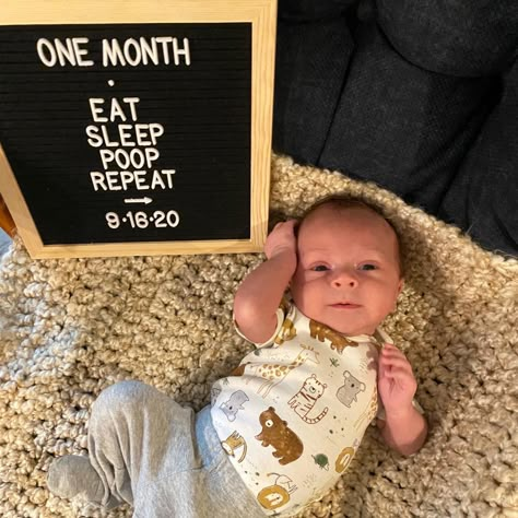 One month baby photo. Photo board says Eat, Sleep, Poop, Repeat. Infant laying on blanket next to sign. Newborn One Month Quotes, One Month Old Milestones Photo Ideas, One Month Old Photoshoot At Home, Baby Boy Monthly Milestone Ideas, 1st Month Photoshoot Ideas At Home, Boy 1 Month Photo Ideas, One Month Milestones Baby Photos, 1 Month Picture Ideas, 1 Month Newborn Photo Ideas