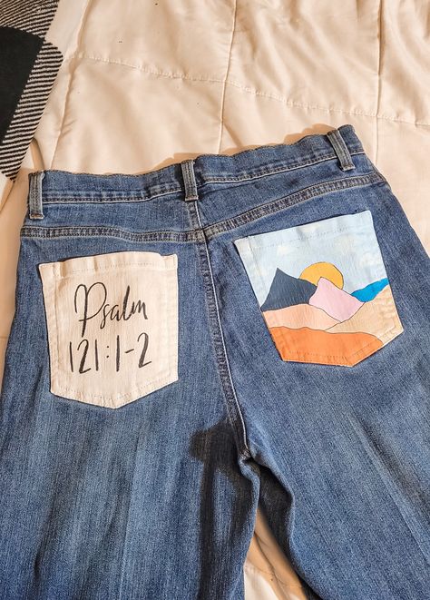 Painted jeans, Christian painted design, aesthetic painted jeans, Psalm 121 painted design, butt pocket painted jeans, back pocket. Jeans Back Pocket Design Paint, Aesthetic Painted Jeans, Painted Jean Pockets, Painting Wardrobes, Hoco Jeans Painted, Senior Jeans Ideas High Schools, Senior Jeans Painted, Hoco Overalls, Diy Jean Skirt