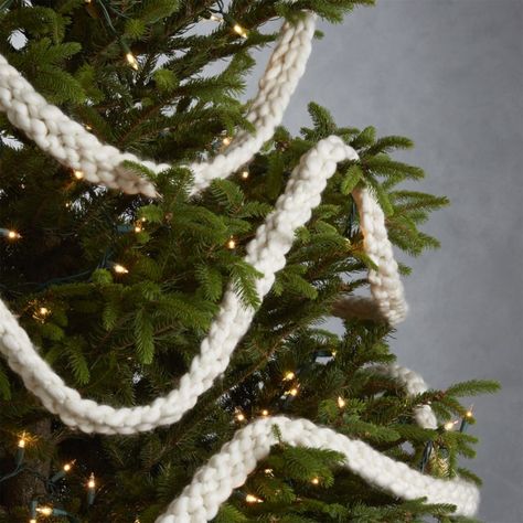 Shop Cozy Knit Ivory Garland. Wound around a banister or draped on the mantel this hand knit ivory garland creates a cozy ambiance with its chunky weave of cuddly wool-blend yarn. Bohemian Christmas, Christmas Tree Decorations Diy, Christmas Tree Garland, Tree Garland, Natural Christmas, Christmas Inspo, Boho Christmas, Cozy Knit, Plaid Christmas