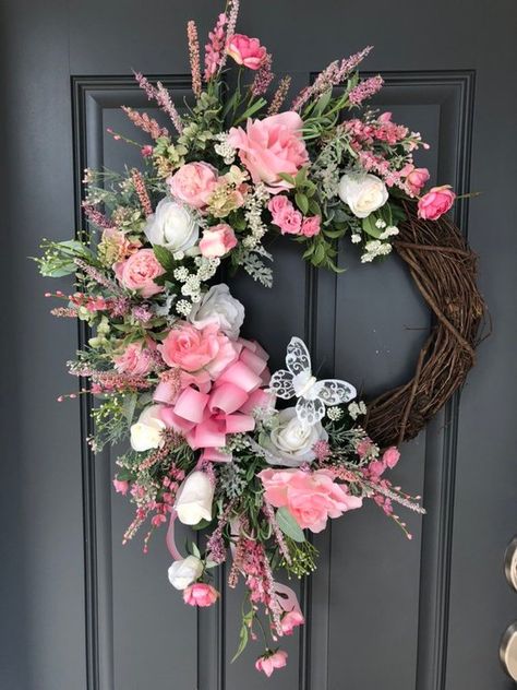 This elegant grapevine wreath is a perfect way to welcome spring and summer. Made with beautiful pink roses, white roses, soft greenery, muted greenery with pink buds and accents of pink and soft lavender picks. A pink ombré ribbon and a lacy white butterfly add the final touches. Butterfly can be Diy Door Wreaths, Grapevine Wreath Ideas, Decorating Wreaths, Wreaths Summer, Floral Door Wreaths, Door Stoppers, Spring Floral Arrangements, Deco Wreaths, Silk Florals