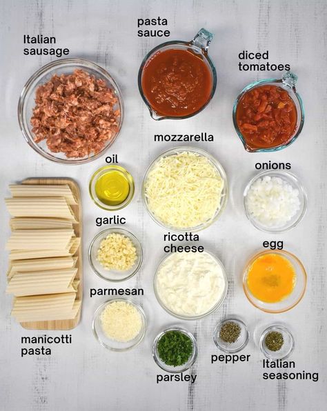 This baked manicotti is stuffed with a three-cheese blend and covered with a delicious Italian sausage tomato sauce. It is easy to make with a combination of fresh and pantry ingredients giving the pasta a homemade taste in a fraction of the time. Pasta Manicotti, Manicotti Dinner, Easy Baked Manicotti, Ricotta Manicotti Recipe, Stuffed Manicotti Shells, Sausage Manicotti, Cheese Manicotti Recipe, Easy Stuffed Manicotti, Manicotti Recipes