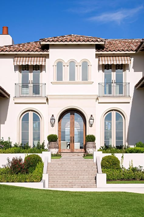 These Mediterranean-inspired homes showcase timeless style with global appeal. With ties to historic European architecture, Mediterranean-style homes remind of sun-soaked, seaside locales. #curbappeal #mediterraneanstylehomes #mediterraneanhouseexterior #mediterraneanhousedesigns #bhg Mediterranean Exterior Homes, Luxury Mediterranean Homes, Mediterranean Homes Exterior, Mediterranean Exterior, Home Designs Exterior, California Architecture, Mediterranean Revival, Clay Roof Tiles, Mediterranean Style Home