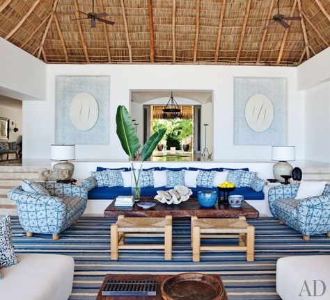 At a Mexican beach house by Martyn Lawrence Bullard, the living room sofa, with seat and back cushions of Chameleon fabric by Perennials, is flanked by custom-made chairs upholstered in Kaba Kaba linen by Bullard. Niches in the rear wall display Bali-inspired stenciling by artist Kelly Holden. Beach House Interior Living Room, Mexican Beach House Decor, Lake House Decor Living Room, Mexican Beach House, Chic Beach House, Mexican Beach, Beach House Interior Design, Dream Beach Houses, Mexican Home