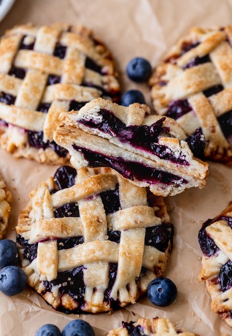 These mini blueberry pies are small pies you can hold in your hand! They have flaky pie crust with lattice work on top. In the middle is a blueberry pie filling with a little bit of cinnamon. If you are looking for an easier version of blueberry pie, these are for you! Easy Flaky Pie Crust, Mini Blueberry Pies, Blueberry Pies, Blueberry Pie Filling, Blueberry Desserts, Pastry Pie, Flaky Pie Crust, Blueberry Pie, Blueberry Recipes