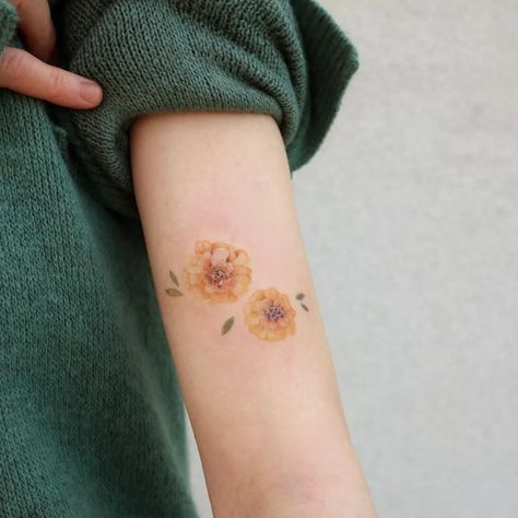 Beautiful Annual Blooms: Birth Month Flower Tattoos | Tattoodo Marigold Flower Tattoo, Month Flower Tattoo, Marigold Tattoo, Cosmos Tattoo, Marigold Color, October Flowers, Korean Tattoos, Beautiful Flower Tattoos, Aries Tattoo