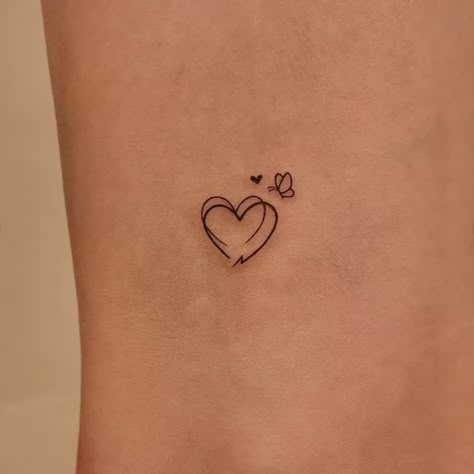 20 Heart Tattoo Ideas You're Bound to Fall in Love With Heart Tattoo On Ribs Cage, Simple Tattoos Heart, Upside Down Heart Tattoo, Behind Ear Heart Tattoo, Lower Back Heart Tattoo, Delicate Heart Tattoo, Heart On Hip Tattoo, Heart Tattoo Fine Line, Side Tattoos Women Ribs Unique