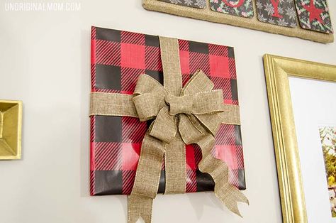 How to decorate a gallery wall for Christmas - great tips! I love the frames wrapped to look like gifts! Picture Wrapped As A Present On Wall, Wrapped Picture Frames Christmas, Wrap Pictures On Wall Christmas, Pictures Wrapped As Presents On Wall, Christmas Wrapped Pictures On Wall, Wrapping Wall Art For Christmas, Frame Wrapping Ideas, Wrapping Pictures On Wall Christmas, Framed Wrapping Paper