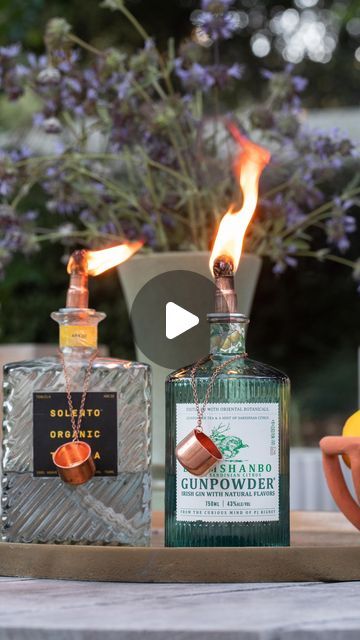 Sugar & Charm / Eden Passante on Instagram: "Turn any beautiful glass spirit bottles into outdoor tabletop tiki torches! These are a great way to light-up a gathering and keep bugs away! They look charming and add a special element to outdoor entertaining.

COMMENT “supplies” and I’ll send you the list! 

You can also find the original post on Sugar and Charm.

This is a great way to reuse those beautiful bottles with gorgeous labels instead of throwing them away. I buy the torch tips on Etsy and they are very well made and look beautiful. Always take the safety caution below  seriously. 

DIY Table Torch Bottles 
1. Gather empty glass bottles with pretty labels, and thoroughly wash them. I save my bottles to make these!
2. Purchase a torch tip with a copper snuffer and cut to size.
3. Fil Patio Oasis Ideas, Table Torch, Alcohol Bottle Crafts, Patron Bottle, Outdoor Torches, Empty Glass Bottles, Beautiful Bottles, Cabin Exterior, Tiki Torches