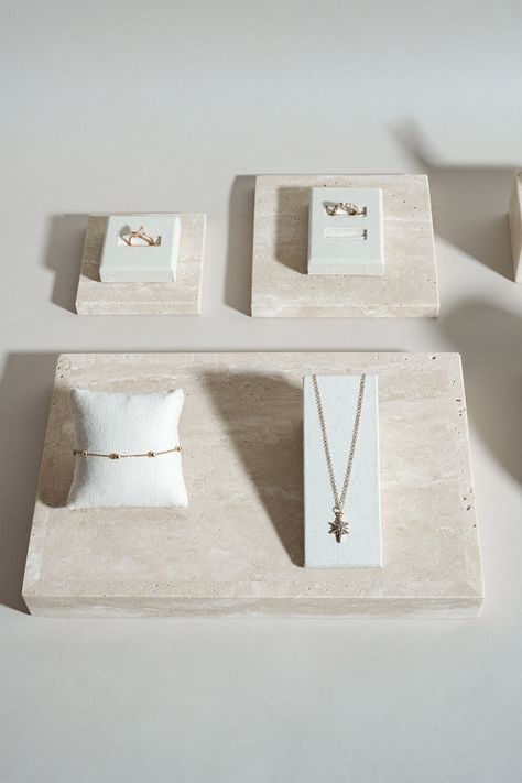 Linen display props and travertine blocks : a dream display duo #jewellerydisplay #displayprop #displayblock Fine Jewelry Display, Jewelry Shop Display, Charm Bar, Display Props, Versatile Jewelry, Decor Display, Shop Display, Retail Display, Jewelry Display