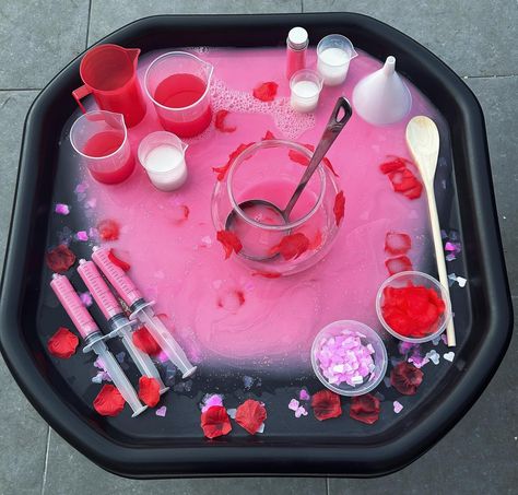 Love Potions 💕 - Valentine’s Day inspired - Water play - Colour mixing - Creative and imaginative play ❤️ Potion base is created using water mixed with pink paint and glitter ❤️ Red and white paint mixed with water in the beakers ❤️ Love heart confetti and fake rose petals in containers and used as decorations #tufftray #tufftrayideas #tufftrayactivities #tufftrayinspiration #tufftrayplay #tufftrayfun #tuffspot #tuffspotideas #playtray #playtrayideas #sensoryplay #waterplay #eyfs #ea... Potion Tuff Tray Ideas, Pink Tuff Tray Ideas, Early Years Creative Activities, February Sensory Table Ideas, Pink Activities For Preschool, Water Play Eyfs, Pink Day Activities Preschool, Valentines Eyfs, Pink Activities