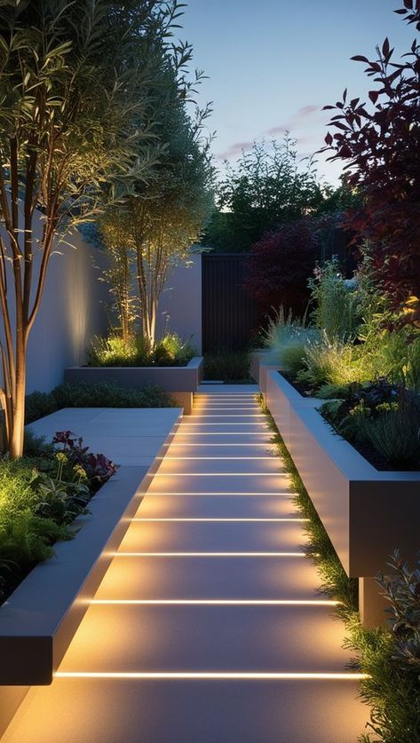 1Landscape Design6 Modern garden with illuminated pathway and lush greenery at dusk. | Sky Rye Design Small Modern Gardens, Outside Landscape Ideas, Simple Home Garden Ideas, Front Door Walkway Ideas, Perimeter Garden, Aesthetic Garden Ideas, Sloping Garden Ideas, Side Yard Ideas, Modern Landscape Design Front Yard