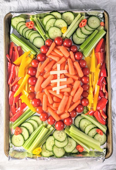 It's easy to make this adorable football veggie tray for your next watch party! Made with fresh veggies in the shape of a football. Veggie Tray Football Party, Football Vegetable Tray, Tailgate Veggie Tray, Football Party Foods For Kids, Charcuterie Board Ideas Football, 40th Football Birthday Party, Football Birthday Party Snacks, Football Fruit Tray, 1st Down Football Birthday Party Food