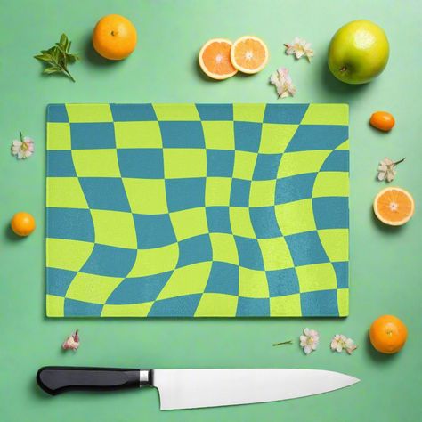 90s style Green colourful check wavy chopping board, the vibrant throwback design will bring a smile to your face while the durable glass surface offers food safe protection for your worktops. This fun piece can protect your surface and can also be used on the table to protect against hot items, its even suitable to serve food on. If you love the 90s and colour this is the board for you. You can shop the matching coasters. High quality, tempered (shatterproof) glass that's hygienic and easy to clean Incredibly durable making it easy to use ever day. Doubles as a serving platter, perfect for gatherings and parties. Made to order in the U.K with high quality materials. Technical Material: Smooth, toughened glass Easy to clean - Dishwasher safe 4 non-slip PVC feet, Hand-printed to order Size: