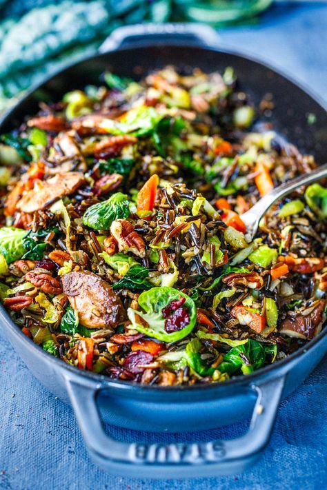 This Wild Rice Pilaf recipe is hearty, textural and savory. Nutty wild rice is paired with mushrooms, pecans, leeks, Brussels sprouts, and craisins. A lovely, colorful side dish that is vegan and gluten-free. Wild Rice Pilaf Recipe, Sprouting Sweet Potatoes, Wild Rice Pilaf, Salty Recipes, Veggie Bowls, Feasting At Home, Wild Rice Recipes, Rice Pilaf Recipe, Pilaf Recipe