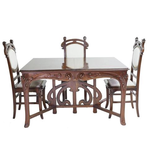 An exceptional Art Nouveau dining suite in walnut comprising of an extension table and six dining chairs that are original to the suite. Table features very well-articulated open and high-relief carvings of whiplash curves, a popular motif during the Art Nouveau period, and offers two original leaves that rest on drawer supports. Suite is from the region of Nord-Pas-de-Calais in France, from the city of Lille or possibly from across the border in Brussels, Belgium. #DiningTable #DiningChairs Art Nouveau Table, Modern Dining Room Chairs, Art Nouveau Furniture, French Art Nouveau, Antique Dining Tables, Patio Chair Cushions, Dining Room Chair, Dining Room Chairs Modern, Extension Table