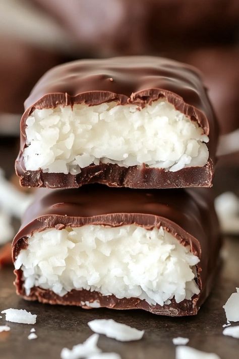 Homemade Mounds Bars - If you're a fan of rich chocolate and coconut, you're going to love these Homemade Mounds Bars! With just a handful of ingredients, these treats come together in no time, offering the perfect balance of creamy coconut filling and a luscious chocolate coating. These bars are a delightful indulgence that taste Homemade Mounds Candy, Coconut Filled Chocolates, Coconut Mounds Bars, Homemade Mounds Bars, Homemade Mounds, Mounds Bars Recipe, Mounds Bars, Mounds Candy, Mounds Bar