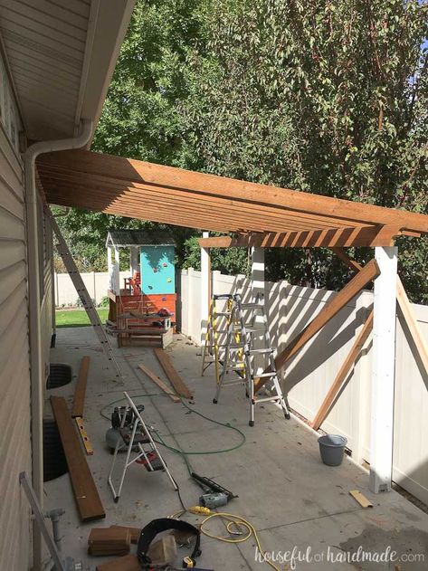 A patio pergola attached to the house is the perfect way to define an outdoor space. And you can build one on a budget in a weekend. See how we built a DIY pergola. Housefulofhandmade.com Covered Patio Ideas, Patio Ideas On A Budget, Small Pergola, Pergola Carport, Building A Patio, Cheap Pergola, Pergola Swing, Joist Hangers, Building A Pergola