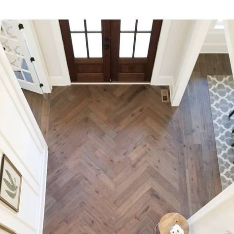 Shannon Homes Design Build on Instagram: "Way to make an entrance! Love how this herringbone foyer floor turned out! 😍 [#eloiseandparo #interiordesigner #interiordesign #residentialdesign #homedecor #homedesignideas #designinspo #herringbone #hardwoodfloors #details #freshclassic #notboring #interiorstylist #interiordesignideas #newconstruction #millwork #naturallight #foyerdecor #frontdoor #pattern ]" Entry Tile Floor Entryway Herringbone, Herringbone Wood Floor Foyer Entryway, Entryway Wood Floor Pattern, Herringbone Tile Floor Entryway, Herringbone Wood Floor Entryway, Herringbone Foyer, Chevron Entryway, Foyer Flooring Ideas Entryway, Herringbone Wood Tile Floor