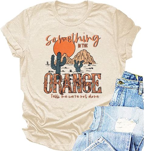 PRICES MAY VARY. Feature:Women western shirt,something in the orange letter print tees,cowboy country music tee tops, western desert graphic t shirt. Round neck, retro vintage western design, casual loose fit, high-quality material texture. Style: Country music Western style T-shirt, casual hippie and denim top. It is very suitable for mothers, wives, daughters, sisters, grandmothers, girlfriends, and friends to express their love for country music. Occasion: This country music enthusiast shirt Something In The Orange, Country Concert Shirts, Country Music Shirt, Country Music Festival, Western Graphic Tees, Country Music Shirts, Retro Western, Music Tees, Country Concert